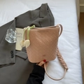 Pink woven leather bucket bag with braided strap and floral tulip charm detail - Pink