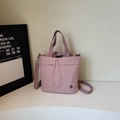 Chic pink drawstring bucket tote bag with adjustable shoulder strap and handle - Purple