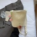 Chic cream woven bucket bag with thick shoulder strap and pink tulip charm detail - Off White