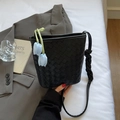 Fashionable black woven bucket bag with long strap and blue tulip charm for women - Black