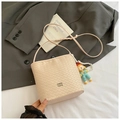 Close-up of woven bucket bag texture with pearl charm and small cartoon doll accessory - Pink With Pendant