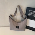 Minimalist grey nylon crescent crossbody bag with adjustable strap and woven label detail - Gray