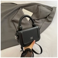 Detail of black pebbled leather mini bag with unique sphere handle and chain strap - Black