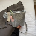 Silver woven bucket bag with braided shoulder strap and pink tulip pendant detail - Silver