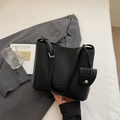 Detail of black pebbled leather bucket bag with adjustable strap and small coin purse charm - Black