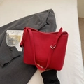 Detail of red lychee grain leather bucket bag with elegant side drawstring bow and strap - Red