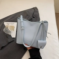 Detail of light blue lychee pattern leather bucket bag with mini neck pouch accessory - Blue