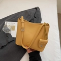 Close-up of bright yellow litchi grain leather bucket bag with matching coin purse accessory - Khaki