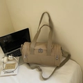 Dettaglio borsa fitness kaki in nylon impermeabile su un morbido lenzuolo bianco a casa - Cachi