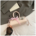 Detail of light pink baguette bag featuring lace edges and checkered bow ornament - Pink