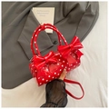Borsa a mano cilindrica rossa a pois bianchi con grande fiocco e tracolla - Rosso