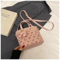 Detailed macro view of pink PU bucket bag with bear patterns and cute charm attachment - Pink With Pendant