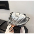 Silver quilted crossbody bag with diamond pattern and metallic chain strap on a black sofa - Silver No Pendant