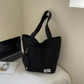 Large black waterproof nylon tote bag with a small detachable round pouch in a daily setting - Black