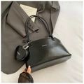 Detail view of black glossy shoulder bag with heart coin purse and silver metal chain - With Ornament / Black