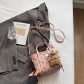 Pink crossbody bag with cartoon bear print and plush dog charm on a stylish background - With Bear Pendant / Pink