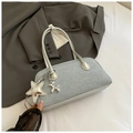 Detail of silver grey Boston bag with a star charm and balloon dog on a dark blazer - Light Blue