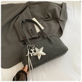 Detail of grey denim boston bag featuring a silver star charm and knotted ribbon trim - Black