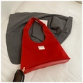 Detail of red velvet tote bag with branded white cloth label on high-quality fabric - Red