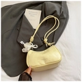 Detalle de bolso hobo de cuero plisado amarillo claro con colgante de mariposa - Amarillo
