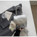 Detail of silver crinkled texture backpack with a plush cat pendant and metal logo - Silver With Pendant
