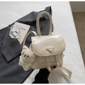 Detail of cream white faux leather backpack with plush bear charm and triangle logo plate - Off-white with Charm