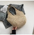 Detailed close-up of woven straw tote bag featuring black trim and contrast stitching - Off White