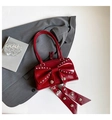 Fashionable red patent leather handbag with oversized bow and silver rivet studs - Red