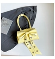 Sweet pale yellow patent leather handbag with large studded bow and dual handles - Yellow