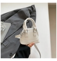 Mini white patent leather shell bag with high gloss finish and metallic zipper detail - White