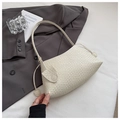 Detailed close-up showing the woven texture and crescent shape of the cream underarm bag - White