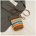 Detail of colorful woven straw mini bucket bag with premium brown leather trim and strap - Multicolor with Brown