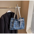 Detalle del bolso tote denim azul con mariposas metálicas y colgante de perlas y encaje - Azul Real Con Amuleto
