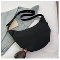 Detail view of the black crescent bag showing nylon texture and leather strap buckle - Black