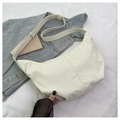 Detail view of cream corduroy hobo bag texture with adjustable strap on white fabric - Off White