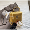Detail of yellow lychee-grain leather box bag with double zippers and top handle - Yellow