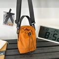 Versatile ginger yellow drawstring bucket bag with adjustable black shoulder strap - Orange