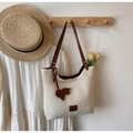 Beige knit tote bag with brown leather straps and a horse charm for summer leisure - Off White