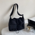 Detail of black waterproof nylon tote bag with drawstring pockets and adjustable shoulder strap - Black