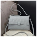 Detailed macro view of light blue leather square bag with geometric embossed texture - Gray