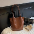 Brown crocodile embossed tote bag with large capacity and minimalist design in a lifestyle setting - Brown