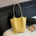 Detail of yellow crocodile embossed texture on a large capacity tote shoulder bag - Yellow