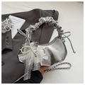 Detail of silver metallic cloud bag with pearl bow, lace trim, and pleated handle design - Silver