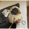 Detailed view of cream ruffled handbag featuring pearl bow charm and heart metal pendants - Yellow with Cloud Pendant