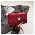 Detail of burgundy crocodile pattern crossbody bag with silver chain and metal lock - Red