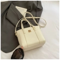 Minimalist beige pebble leather tote bag with gold metal plaque and adjustable strap - White