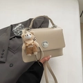 Creamy beige crossbody bag with cute teddy bear charm and silver twist lock detail - With Pendant / Beige