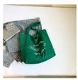 Dettaglio della borsa tote in tela verde con scritte artistiche bianche e tessuto spesso - Verde