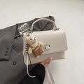 Cream white structured handbag with silver twist lock and a cute plush bear charm - With Pendant / White