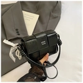 Close-up of black woven leather handbag with lace detail and decorative pearls - Black